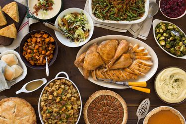 Overhead of a table filled with different Thanksgiving dishes 