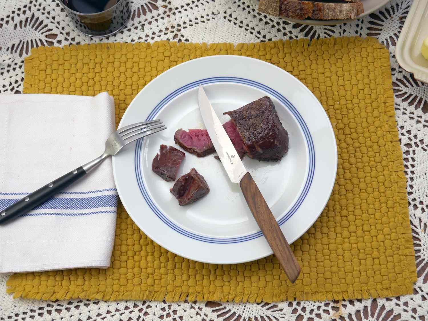 the Victorinox modern steak knife resting on a plate with a sliced piece of steak