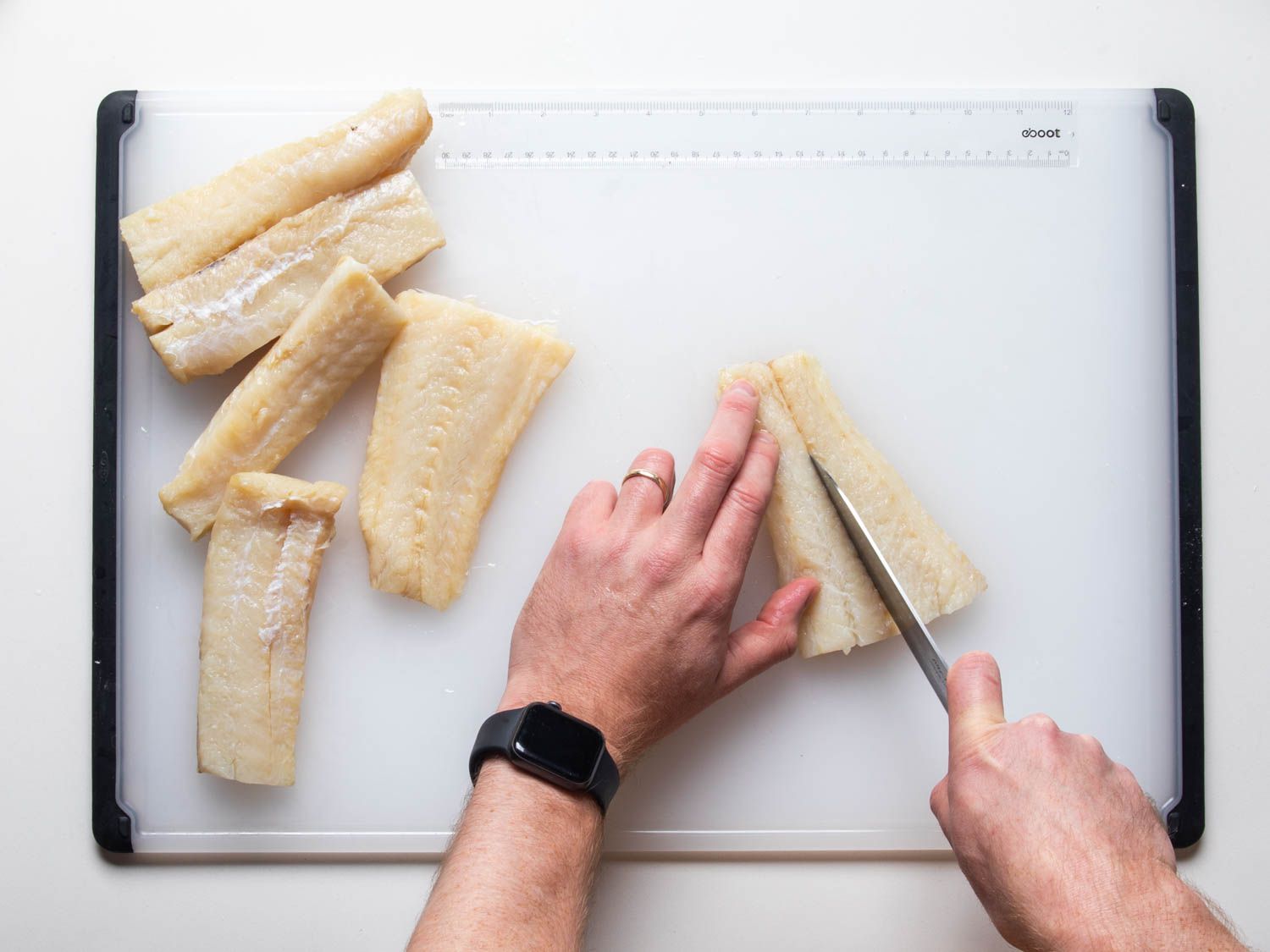 Portioning salt cod fillets into strips