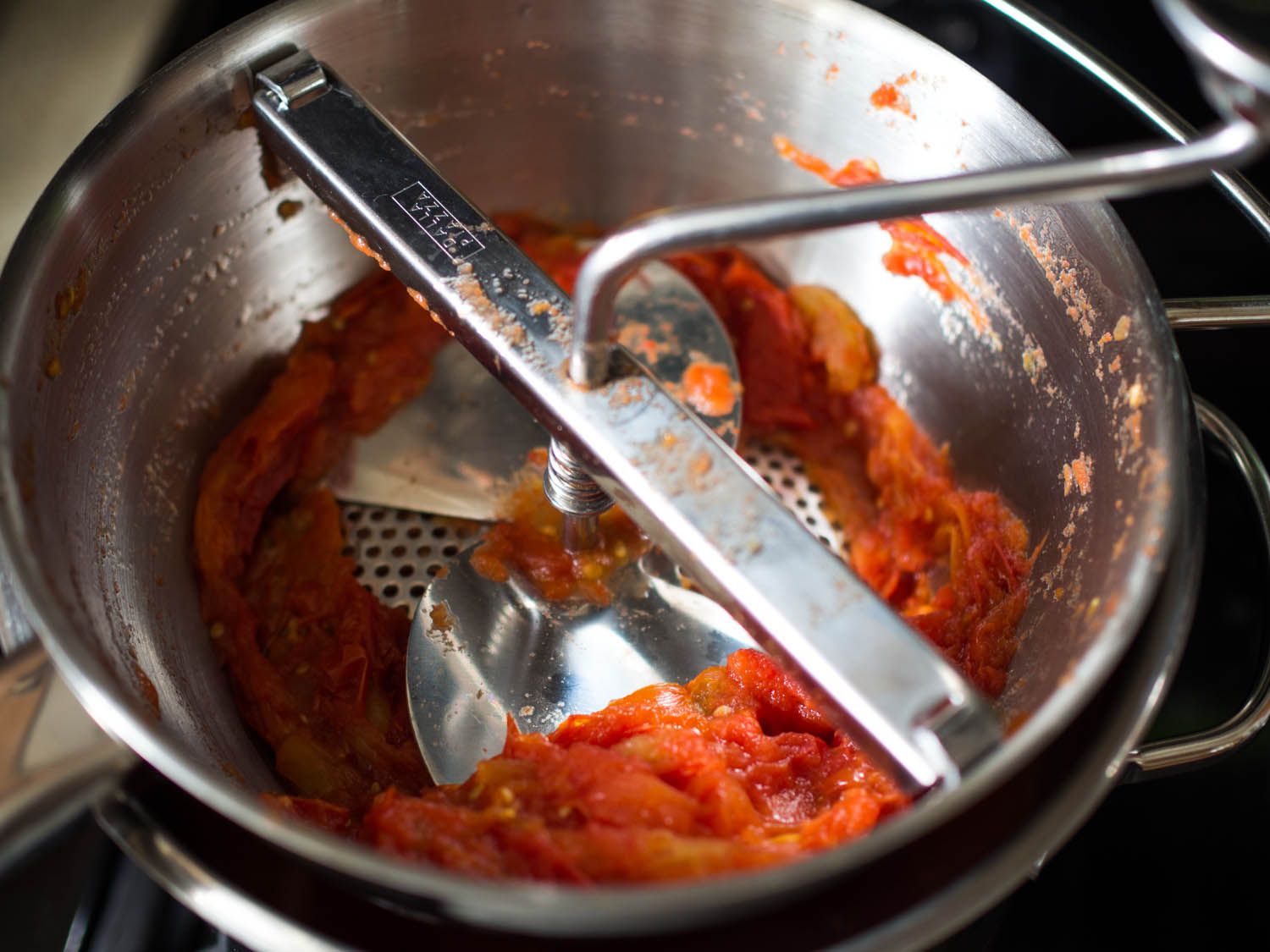 Tomato skins in a food mill after the tomatoes have been milled.