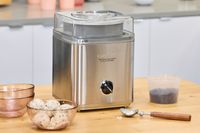 The Cuisinart Pure Indulgence 2 Quart Frozen Yogurt-Sorbet & Ice Cream Maker ICE-30BCP1 on a wooden surface