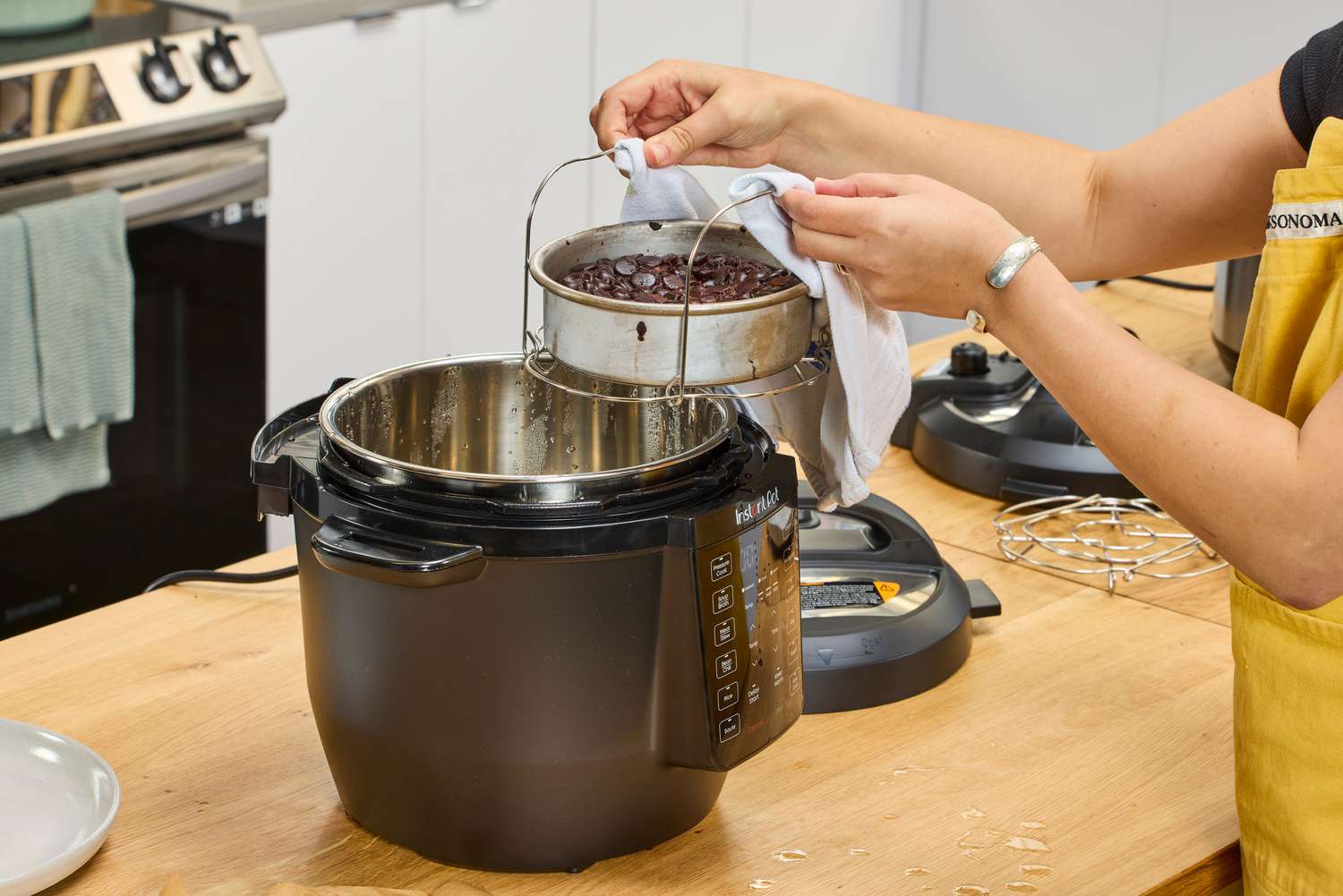 A person removes a cake from the Instant Pot RIO 6-quart Multicooker