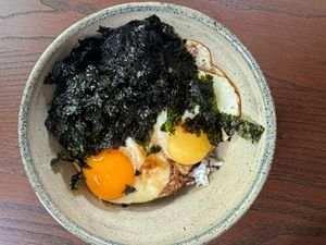 A bowl of gyeranbap a Korean dish with rice fried eggs and seaweed