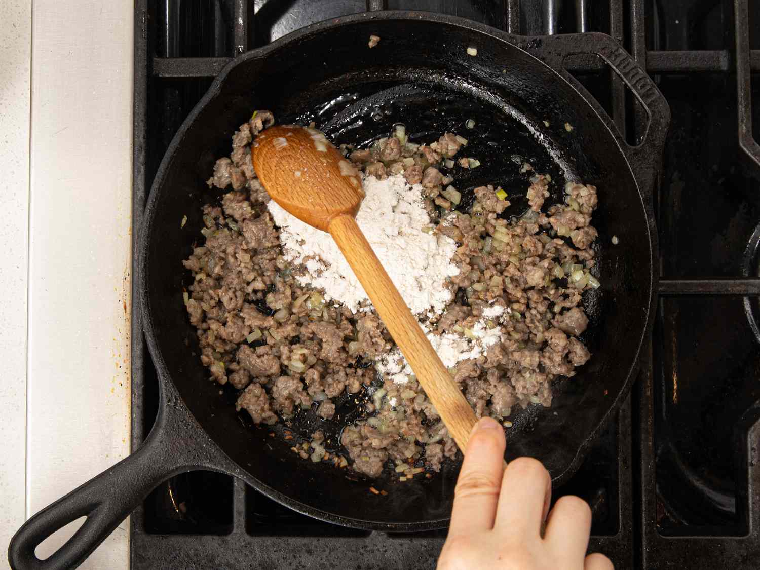 Overhead view of stirring flour