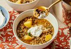 Lebanese brown lentil soup in a bowl with a dollop of yogurt served with pieces of potato and lentils visible