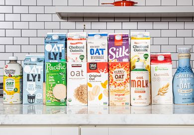 A selection of various oat milk brands displayed on a counter