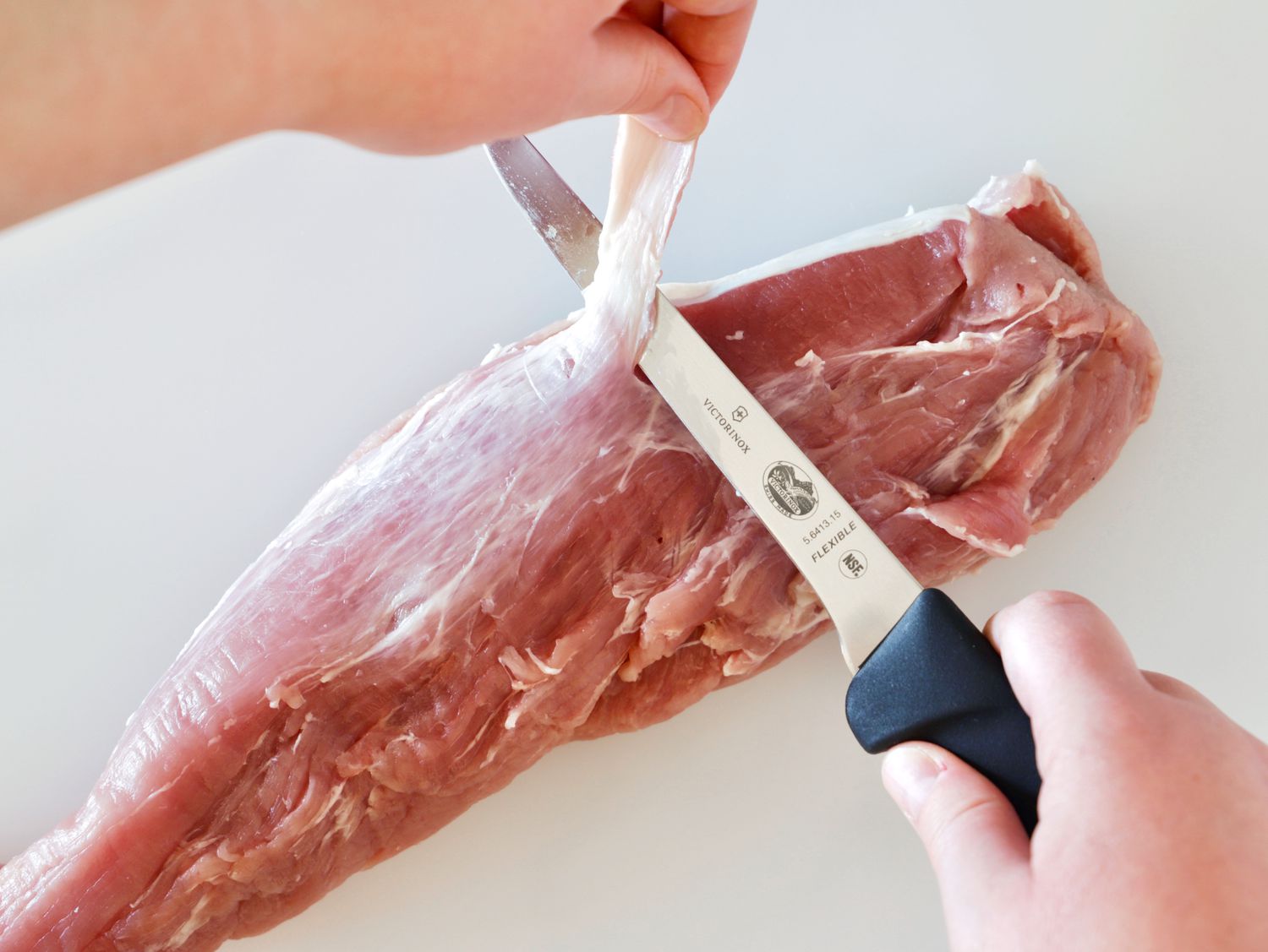 holding the victorinox boning knife trimming the fat
