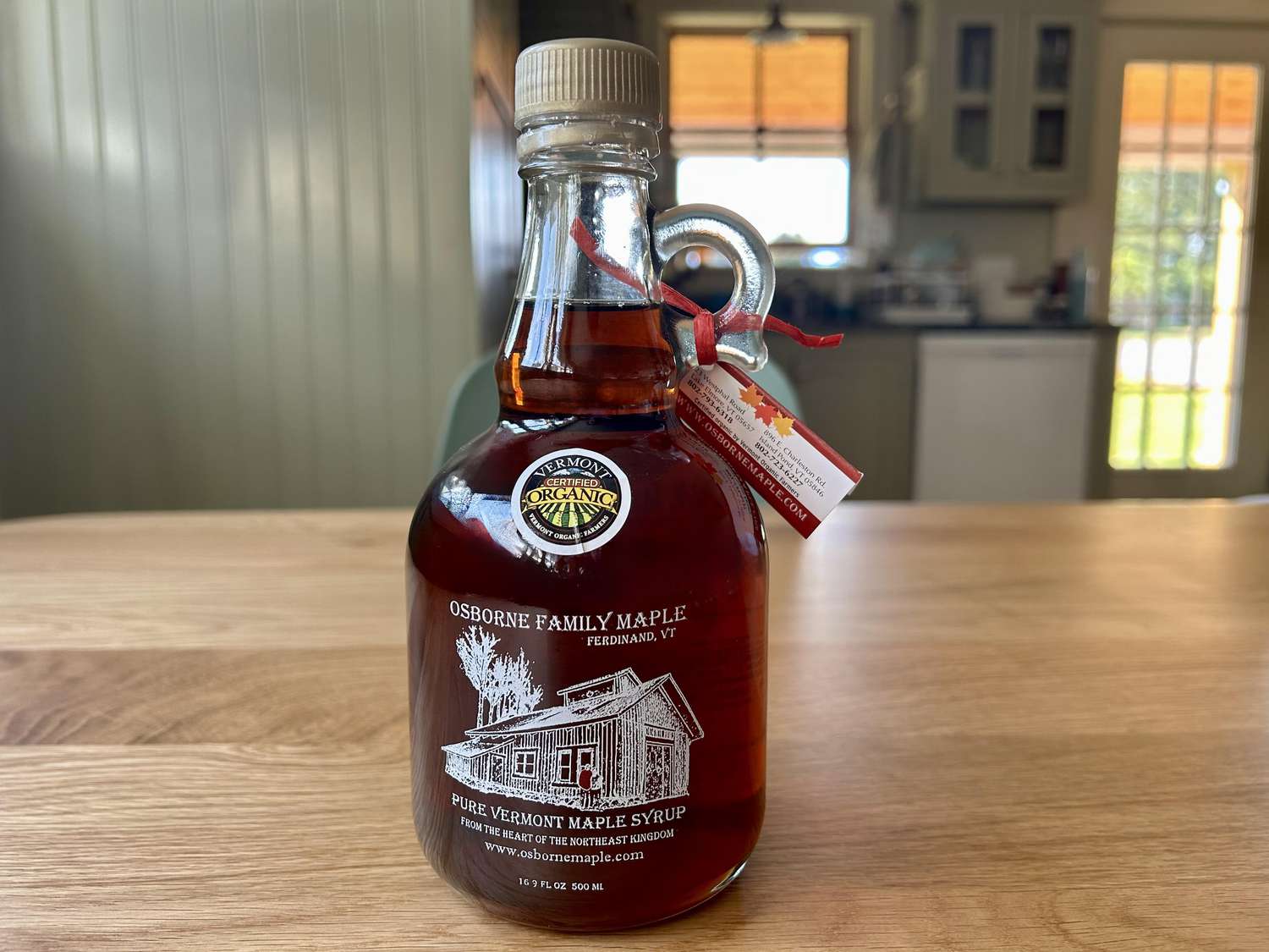 A bottle of Osborne Family maple syrup on a kitchen table