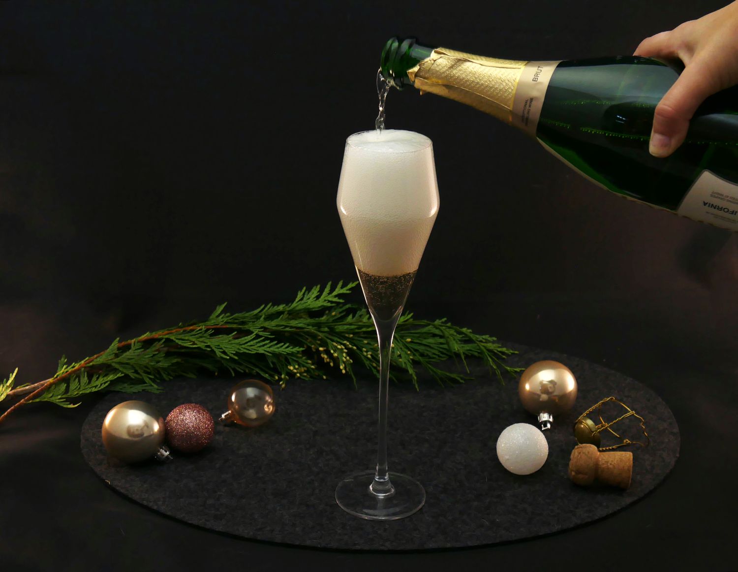 a person pouring champagne into a glass