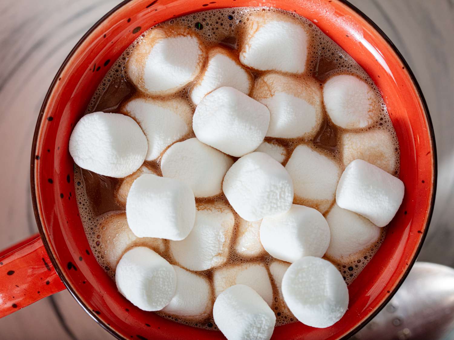 Overhead shot of a mug of hot chocolate topped with marshmallows.