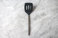 Tovolo Silicone Slotted Turner on a marbled surface