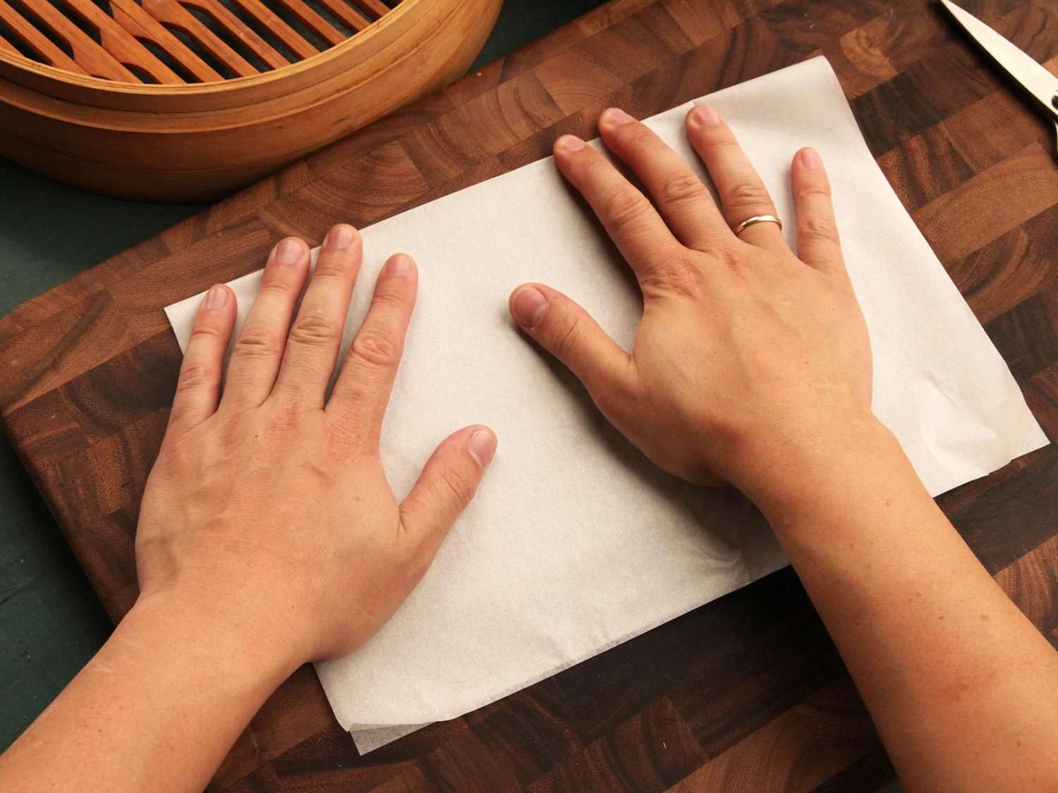 Folding parchment paper in half.