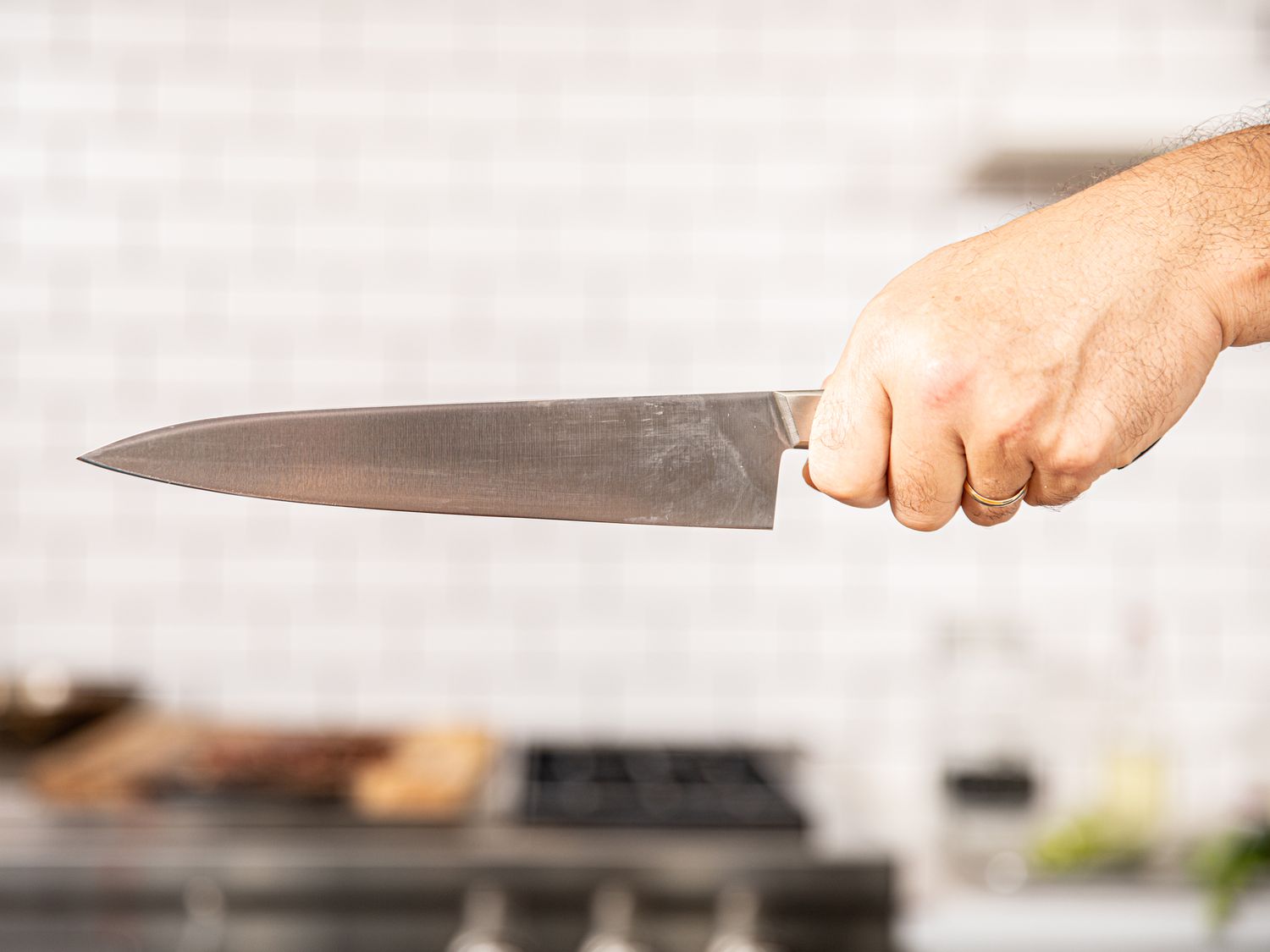 Holding a knife by the handle from the back view