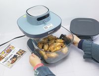 a person pulling out the basket with cooked wings