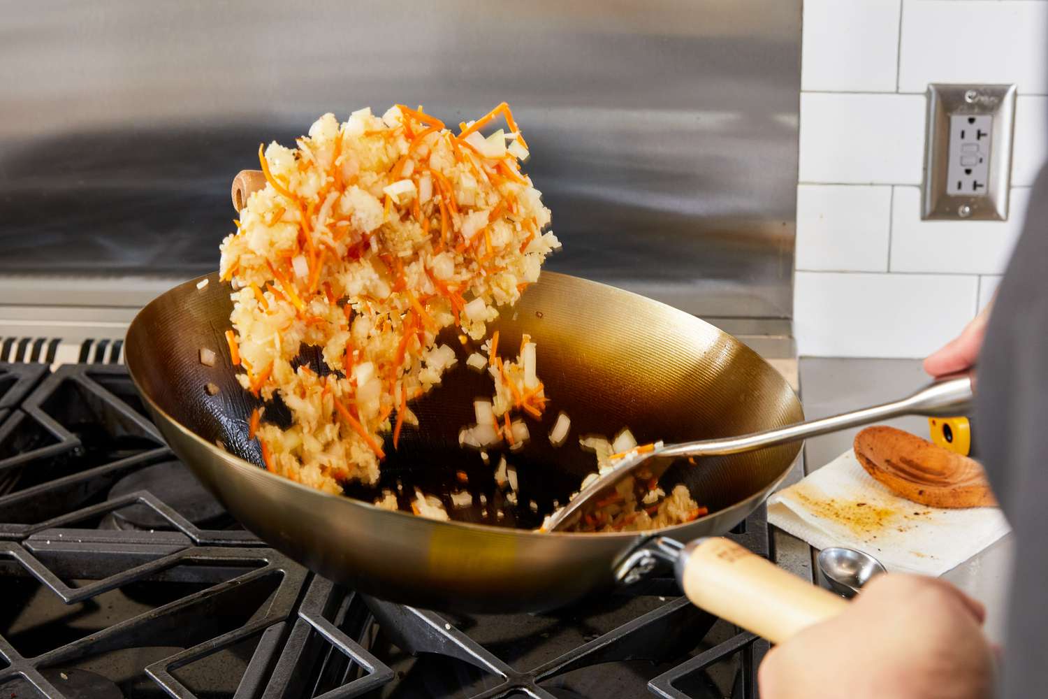 Person cooking food in Joyce Chen Carbon Steel Wok