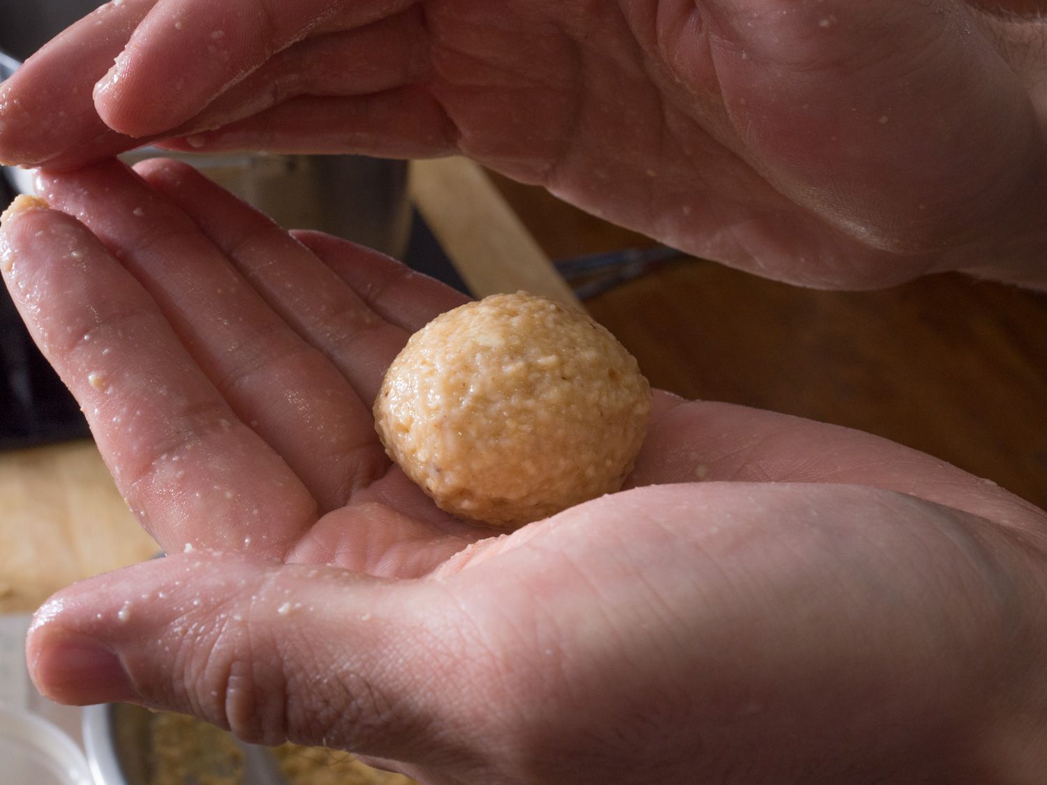 Hands forming a matzo ball.