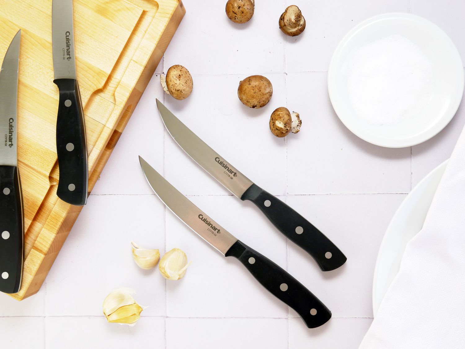 the cuisinart steak knives on a white tile backdrop
