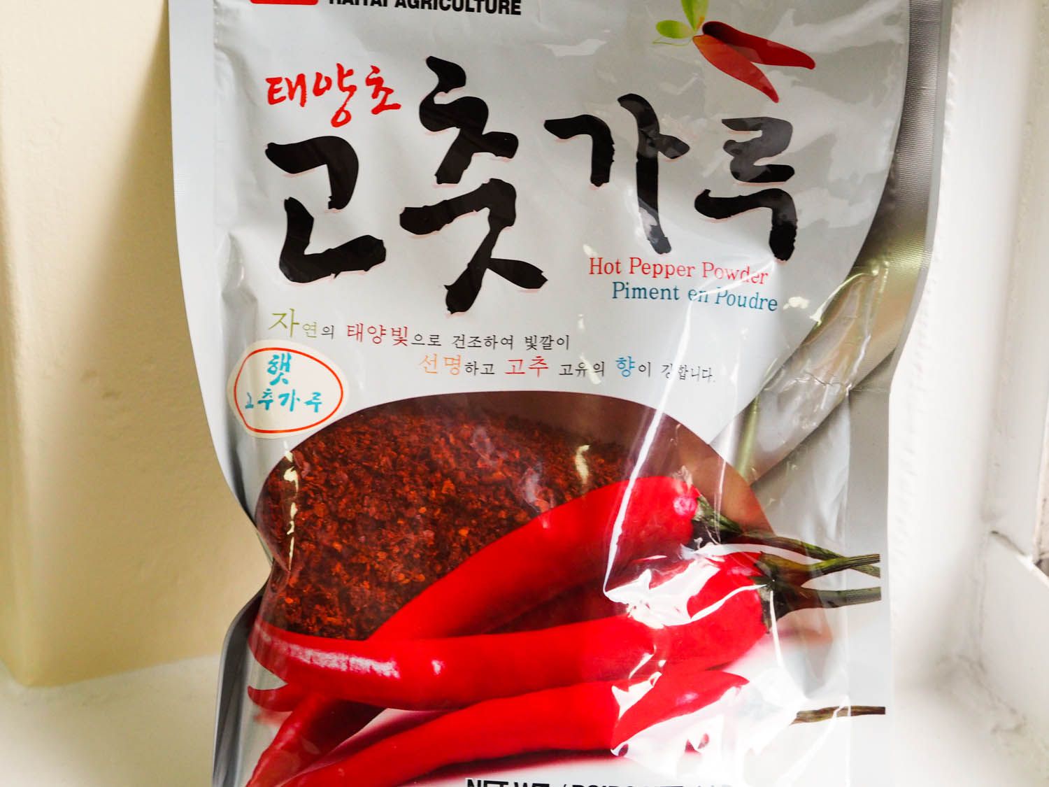 Close-up of a package of gochugaru (Korean chile flakes).