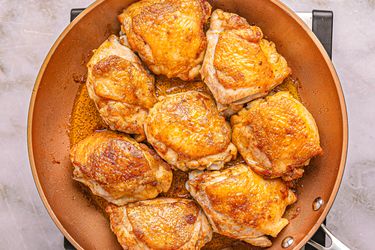 Cooked chicken pieces in a skillet, ready for a recipe or serving