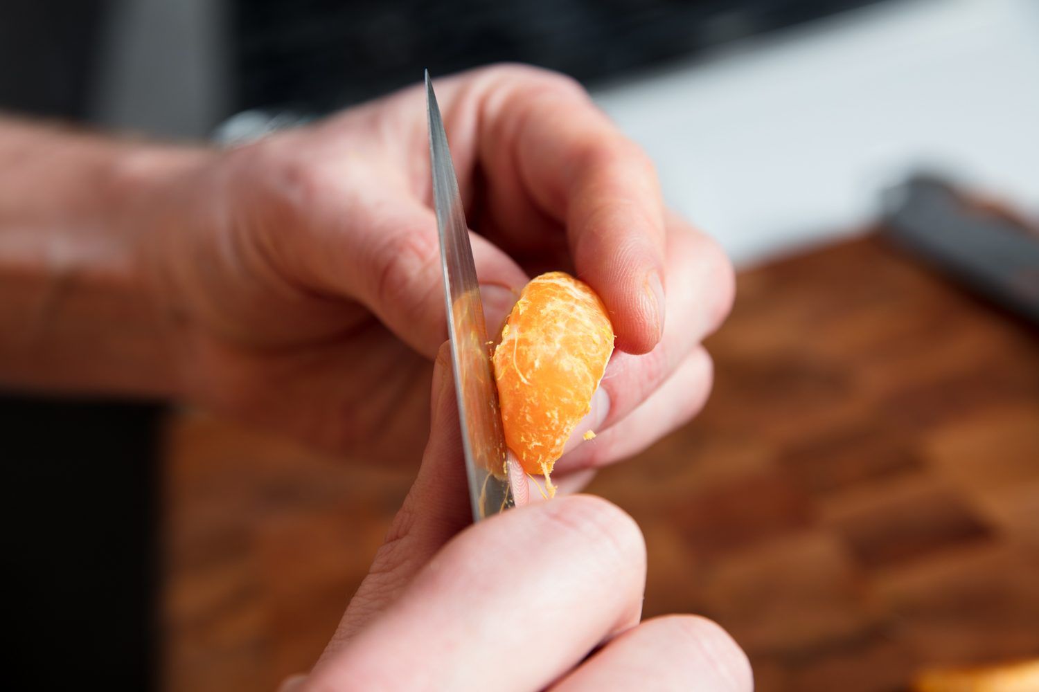 Removing pith from mandarin segments.