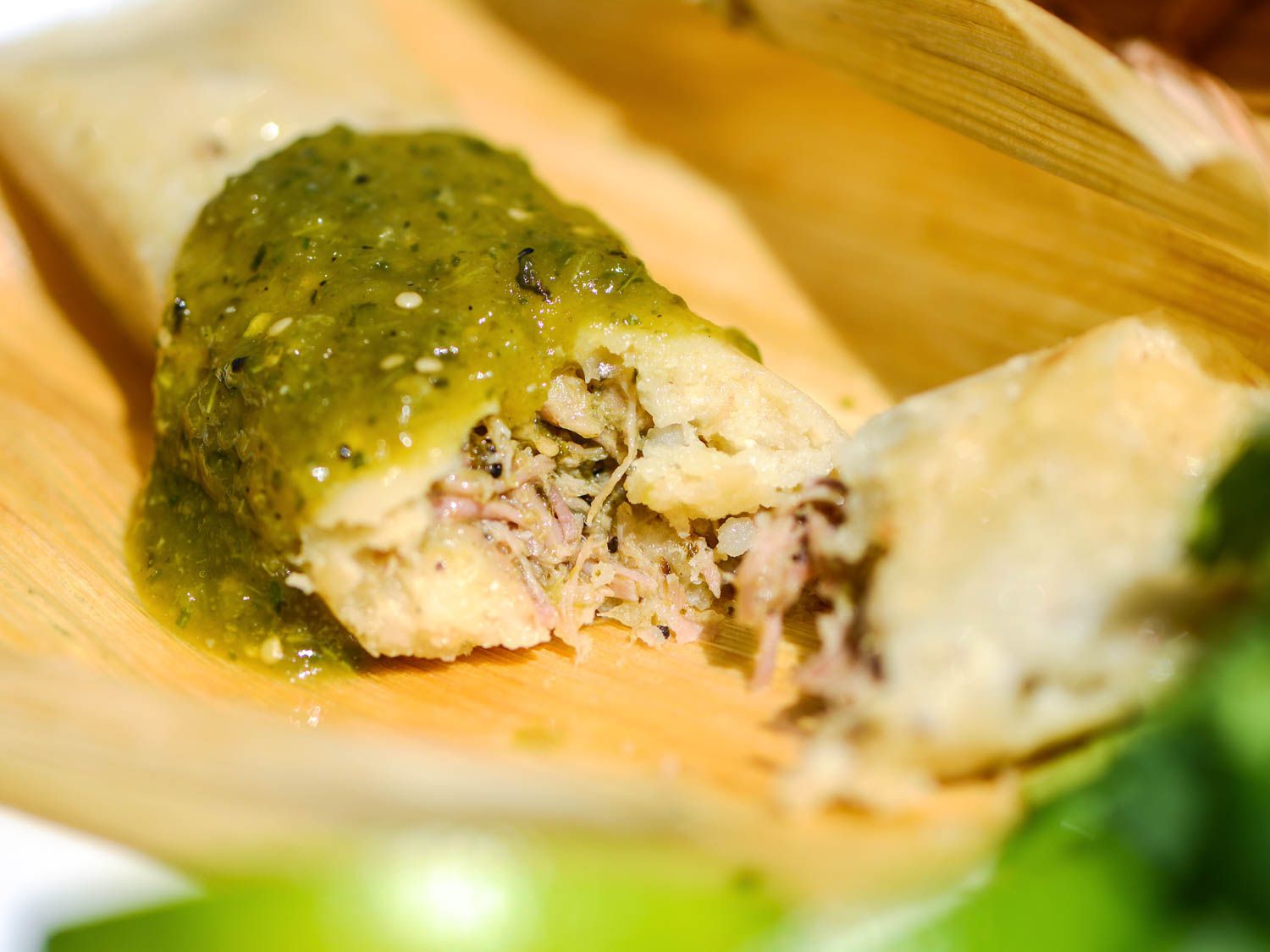 A tamale with green chile and pork
