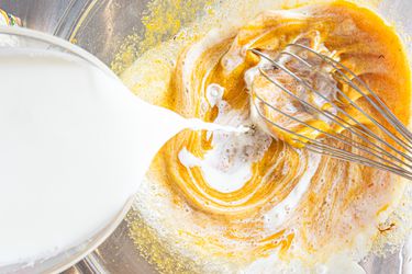 Half and half being poured into a bowl. 