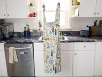 the hedley and bennett smock apron hanging up in a kitchen