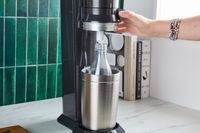 A person using the SodaStream Aqua Fizz.