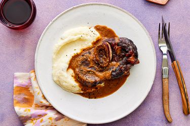 Overhead view of red-wine braised short ribs on a white plate