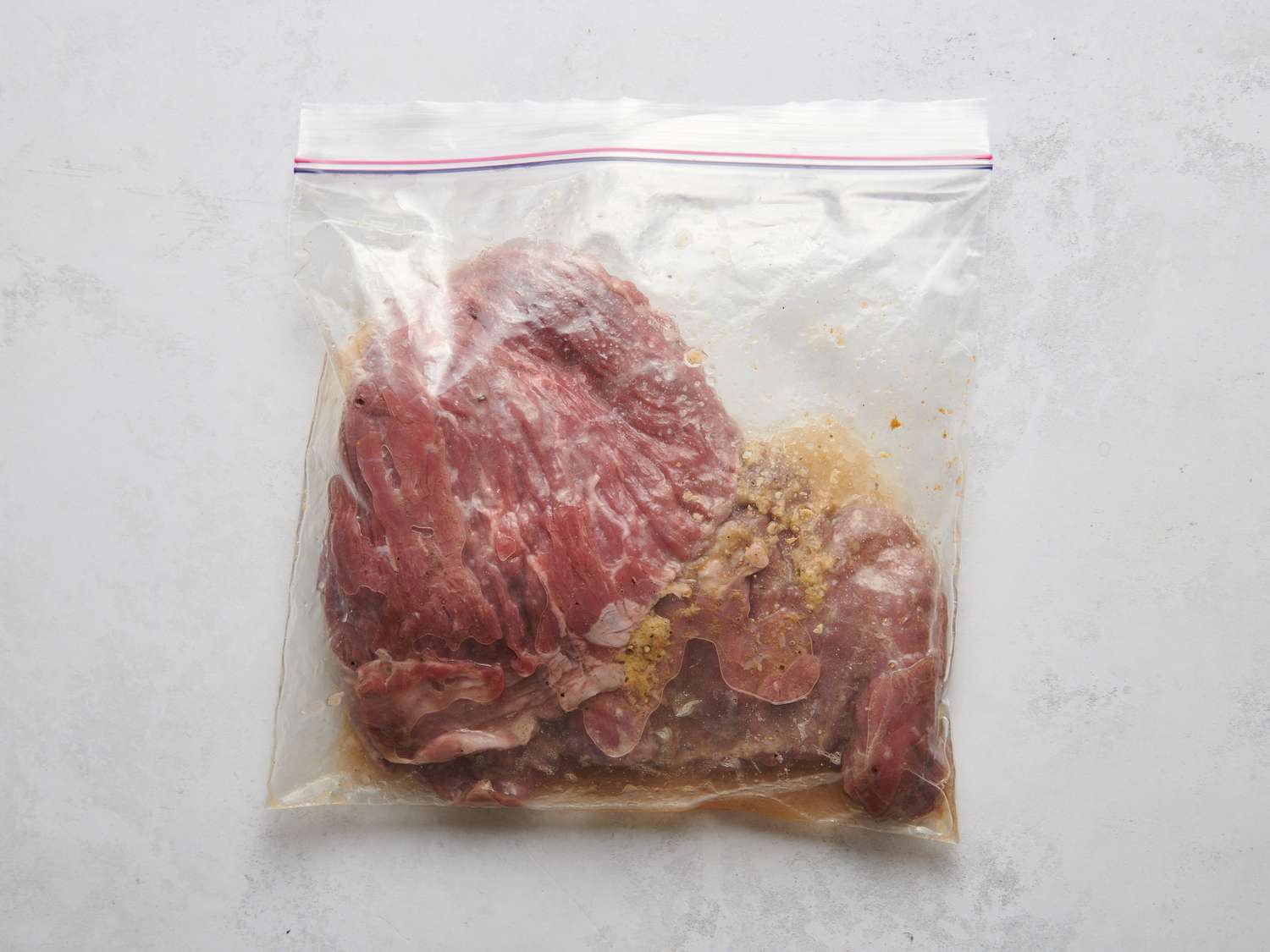 Skirt steak combined with lime and orange juice, â cup of olive oil, garlic, cumin, 1 teaspoon salt, and Â½ teaspoon of freshly ground black pepper inside a resealable bag