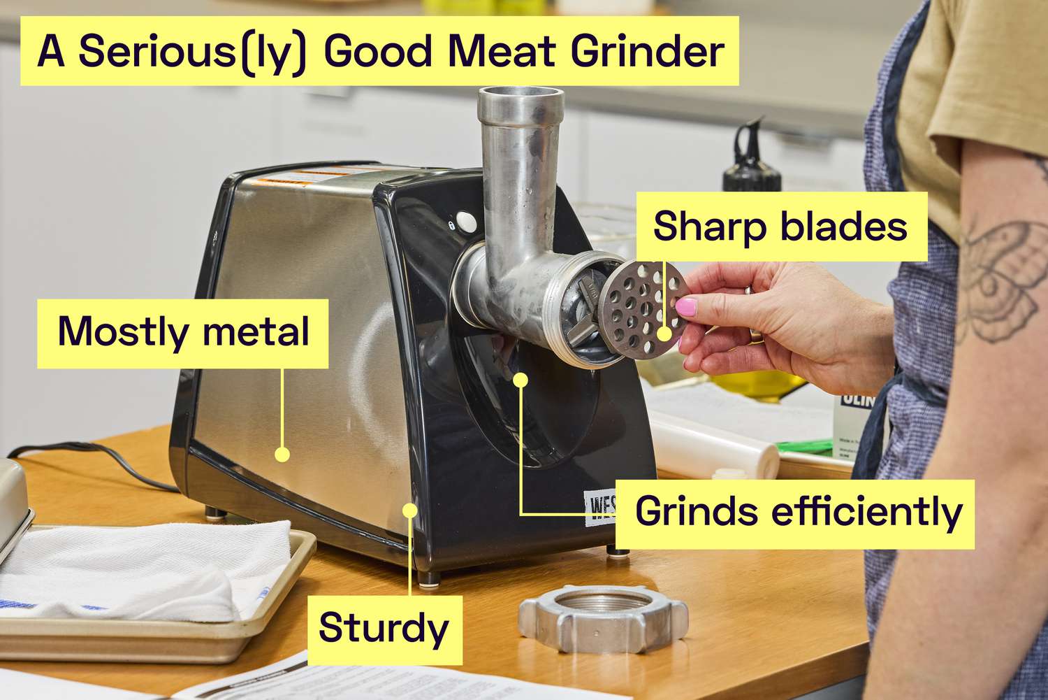 A meat grinder on a kitchen countertop.