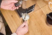 A person froths milk using the Profitec GO Single Boiler Espresso Machine steam wand