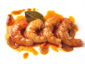 Closeup of Sous Vide Shrimp With Garlic, Sherry, and Smoked Paprika, served on a white plate.