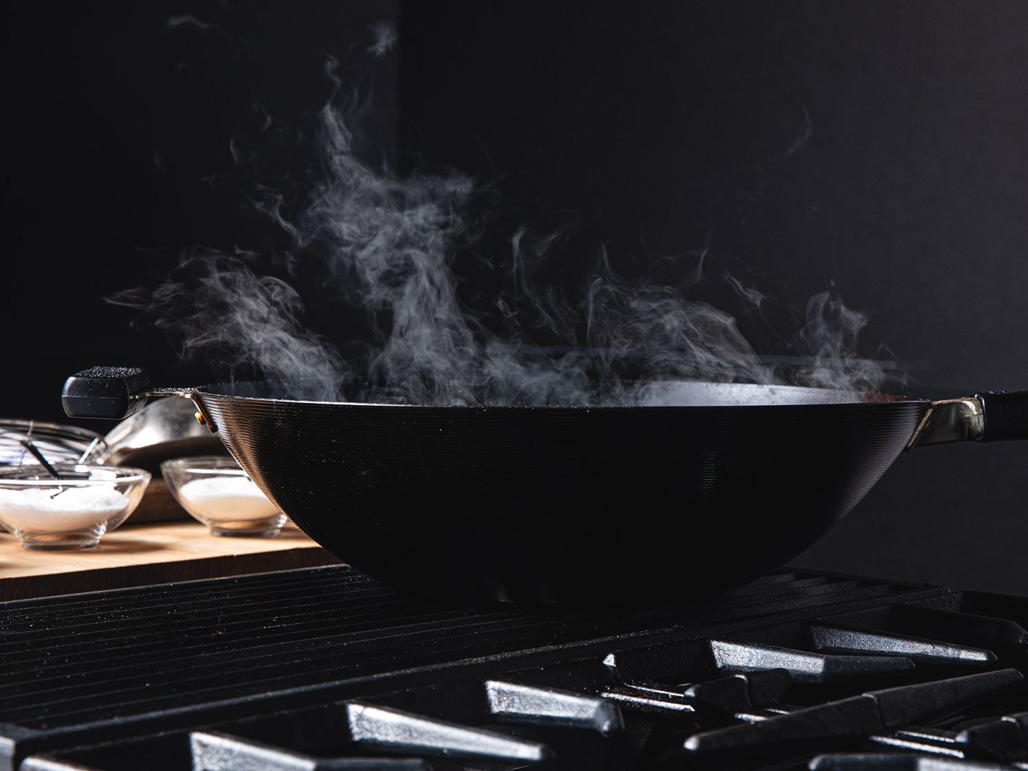 A smoking wok on a stove.