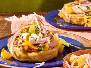 Closeup of breakfast sopes, served on blue plates.
