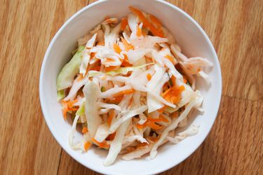 Overhead view of quick curtido in a white bowl.