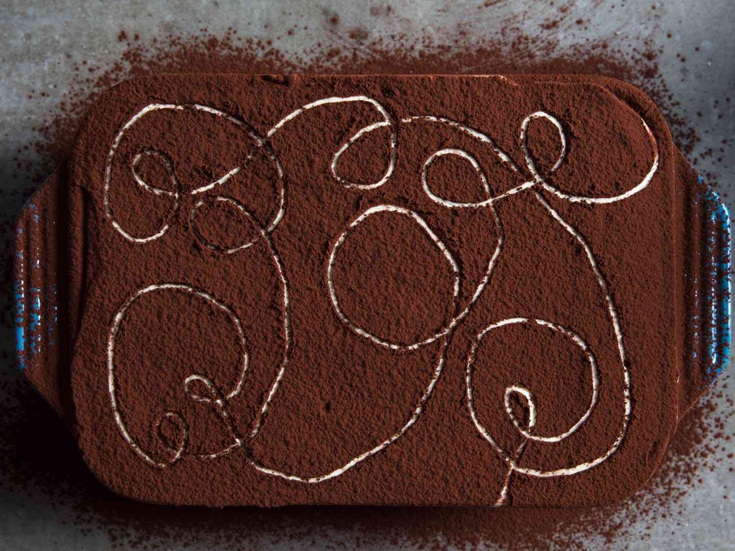 Overhead shot of finished tiramisu in a baking dish. 