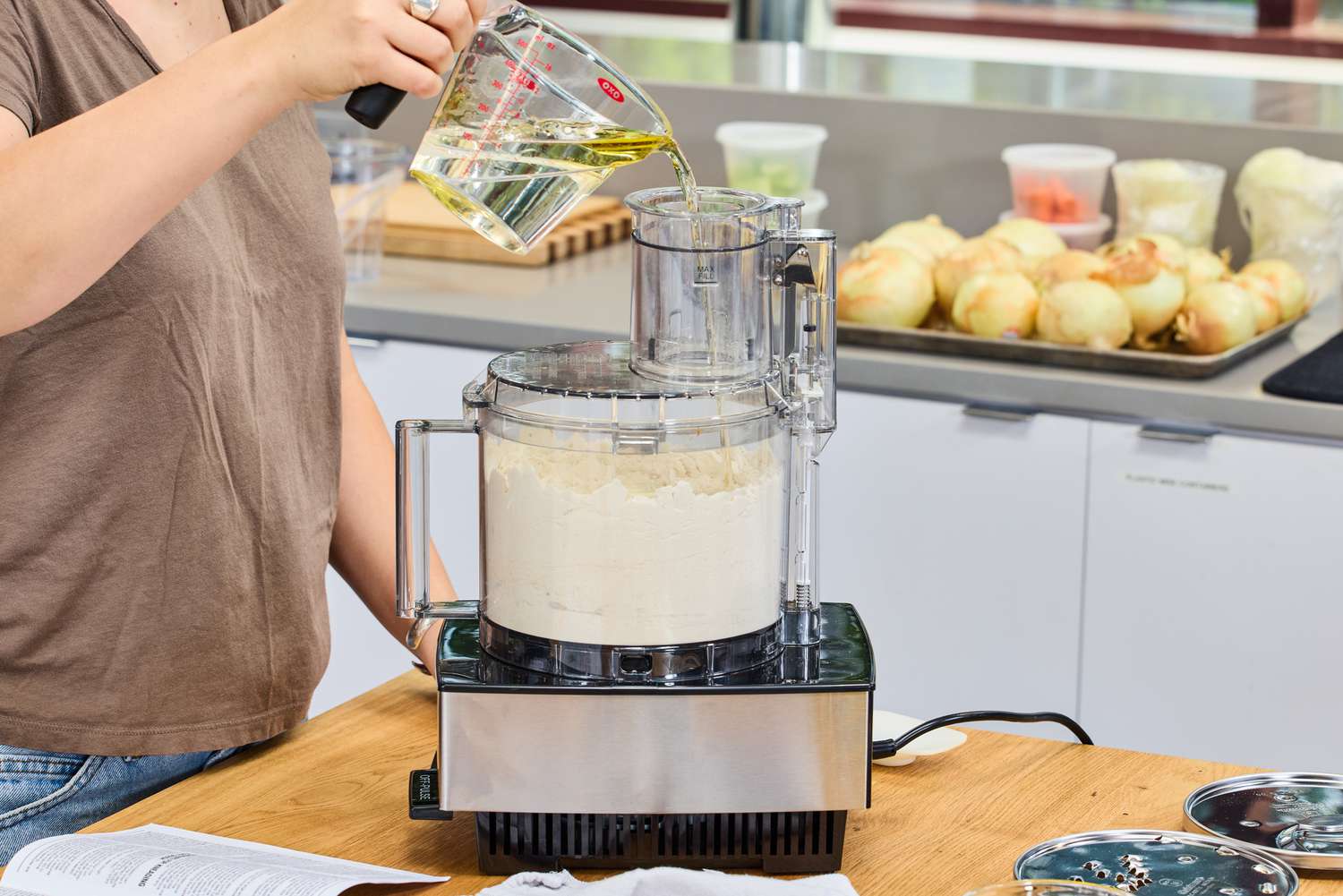 A person pours water into the Cuisinart 14-Cup Food Processor