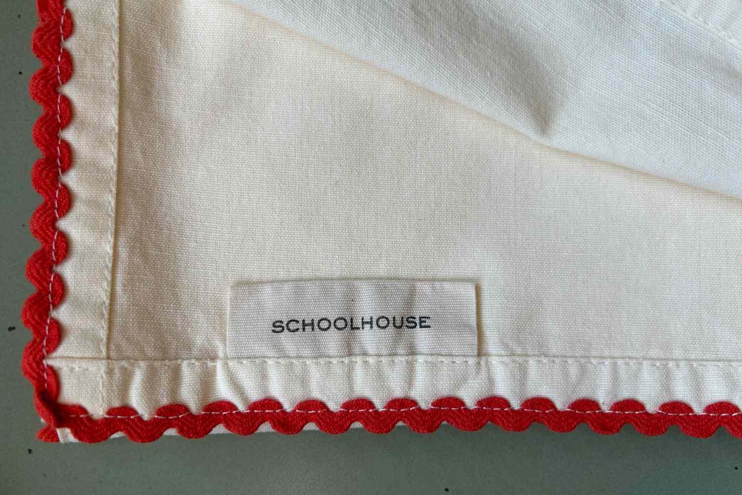 A white cloth napkin with a scalloped edge 