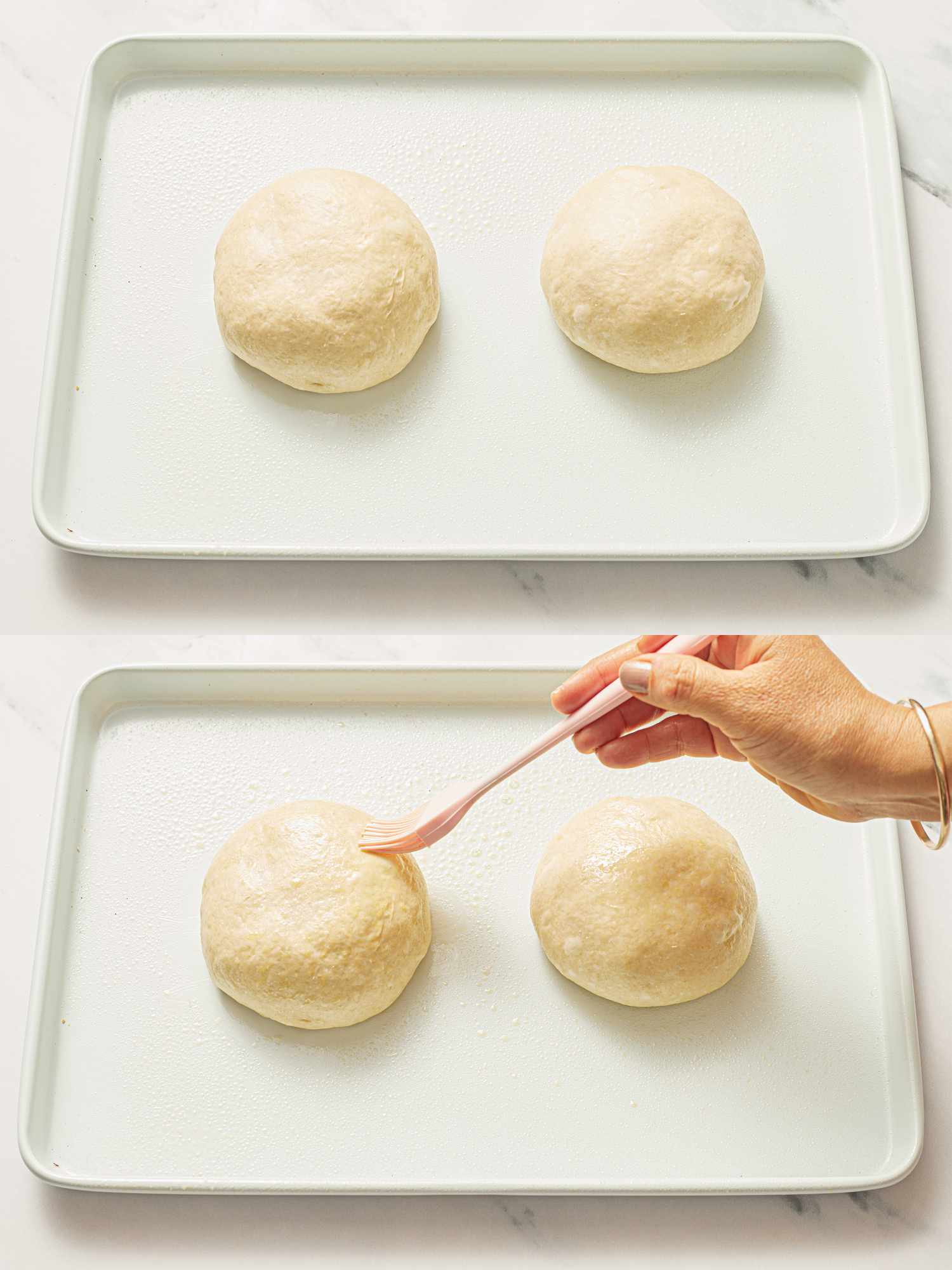 Two dough balls on a tray, a hand pressing a fork onto one of the dough balls.