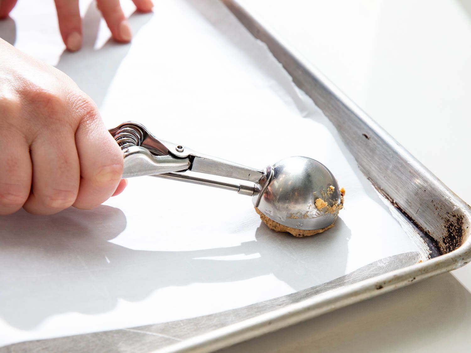 Portioning the cookie dough with a scoop