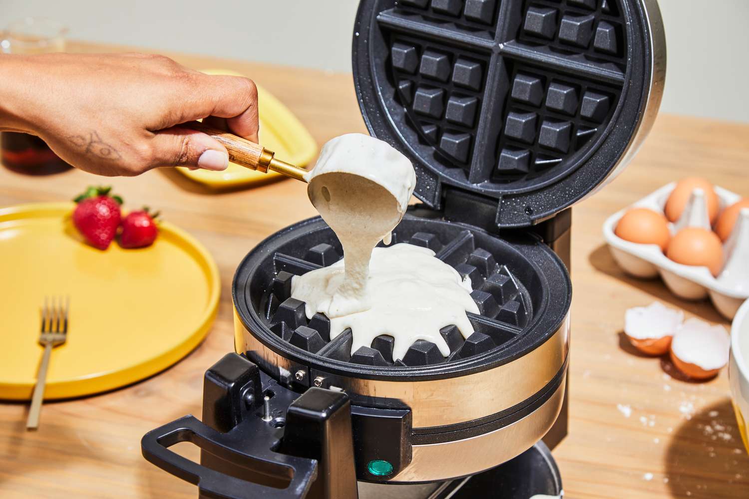 Person pouring batter into Cuisinart WAF-F4 Double Flip Belgian Waffle Maker
