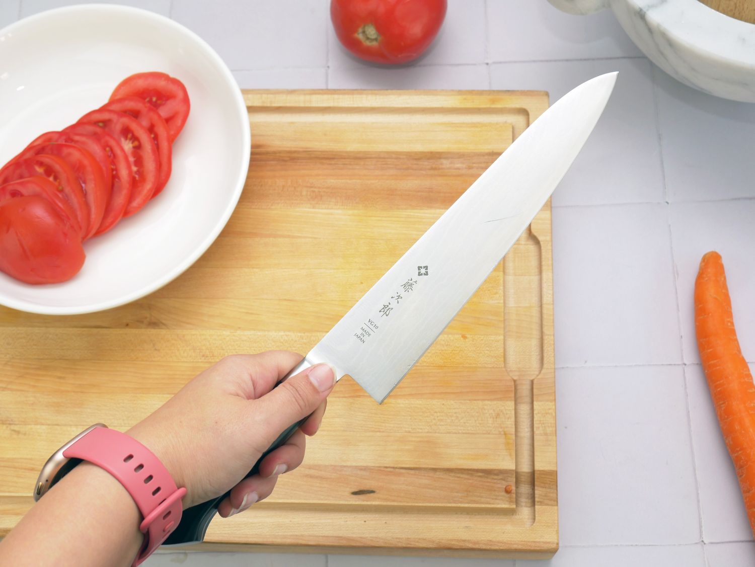 a person holding a chef knife