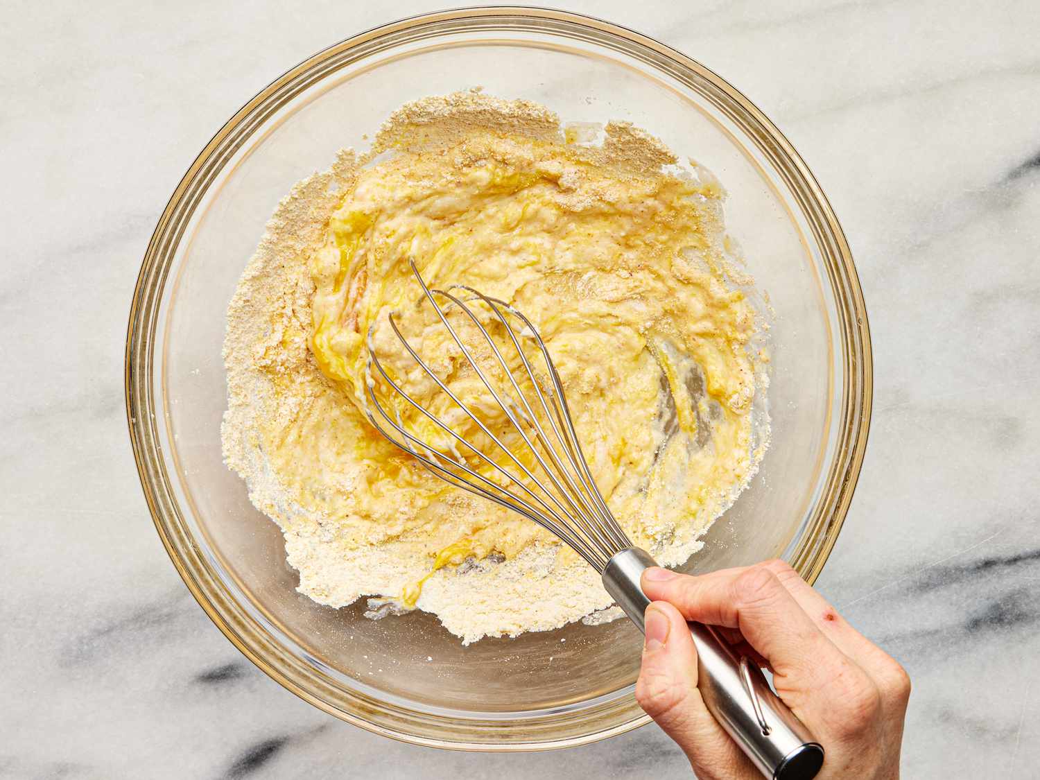 Flour, corn flour, cornmeal and creole whisked together in a glass bowl 
