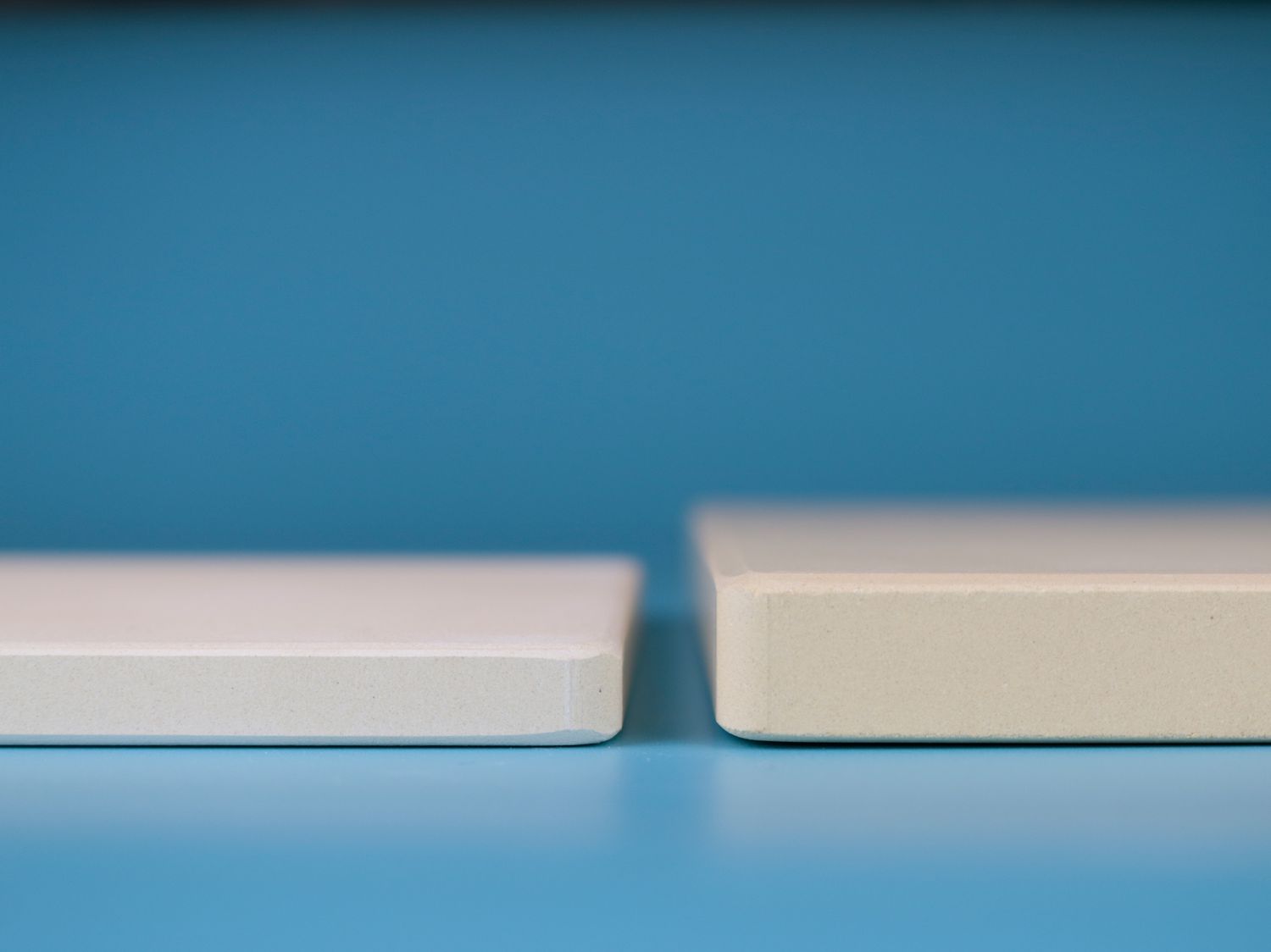 a thick and thin pizza stone side by side in close up