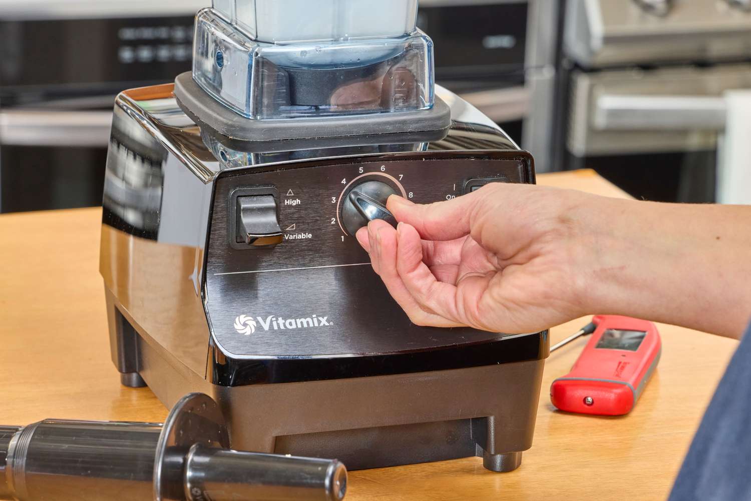 A close-up of a hand turning a nob on the Vitamix 5200 Professional-Grade Blender