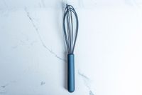 GreenPan Silicone Whisk on a marbled surface