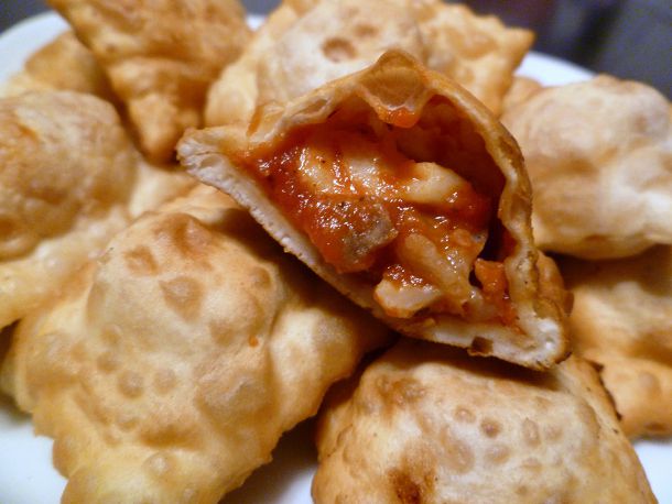 A plate of homemade pizza rolls filled with cheese and tomato sauce