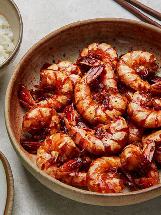 Overhead view of braised shrimp with a side of rice and bok choy 