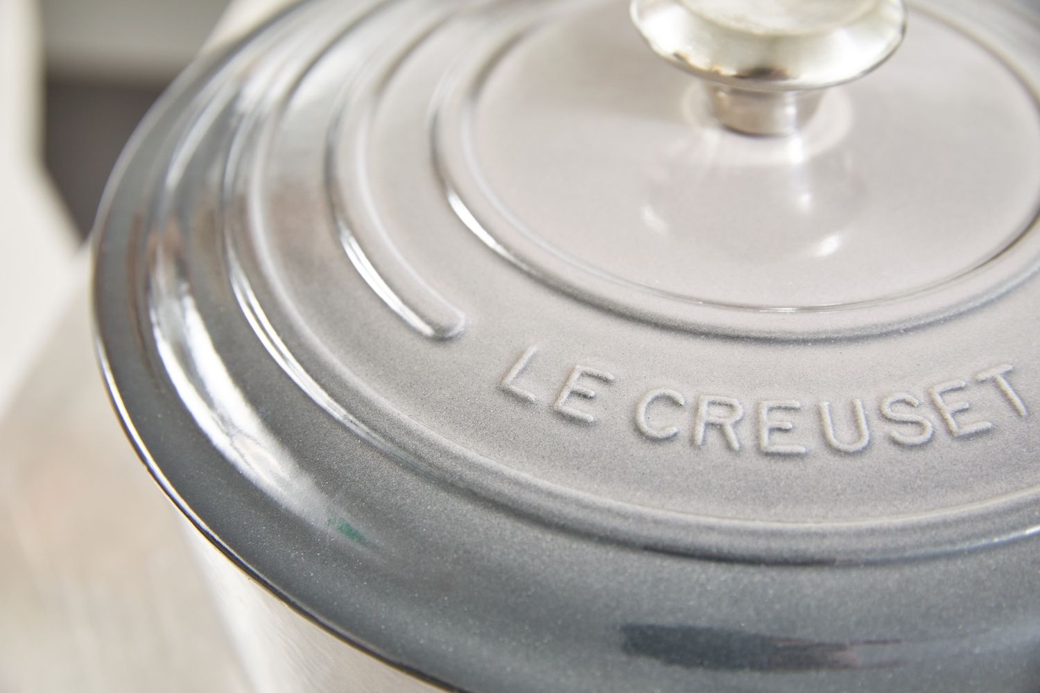 a closeup look at the lid of a grey le creuset dutch oven